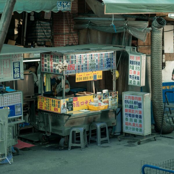 A vibrant street food stall in an urban setting showcasing local cuisine and bustling city life.