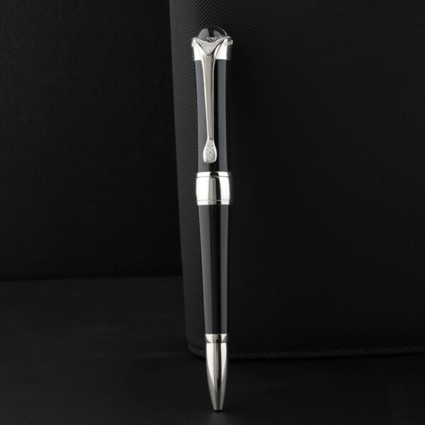 Sleek black pen with silver accents on a textured black surface, exuding elegance and luxury.