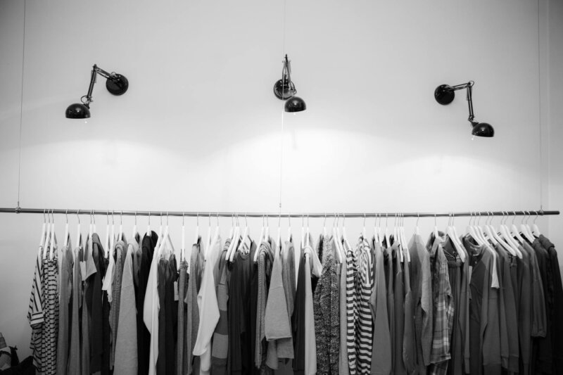 Minimalist black and white clothing display in a stylish boutique setting.