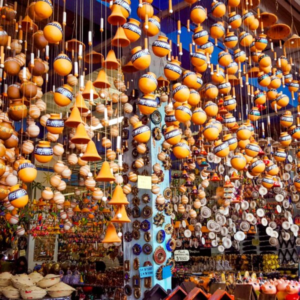 Low angle of various traditional lamps and clay products hanging on stall in local bazaar