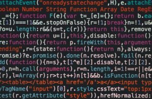 Close-up of colorful coding text on a dark computer screen, representing software development.
